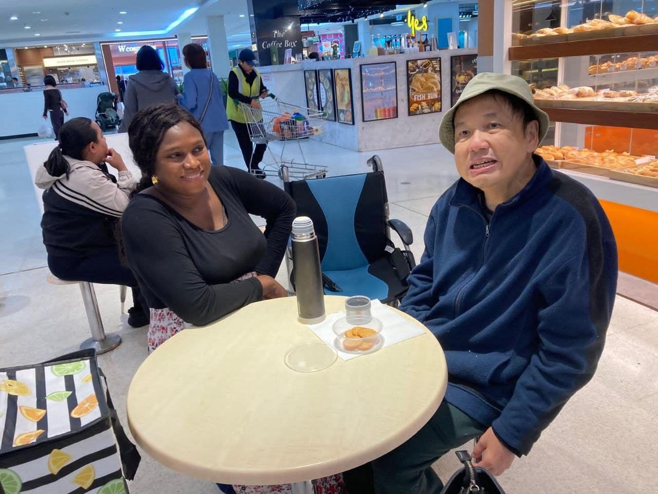 Hive Disability support worker spending time with a participant during a community outing