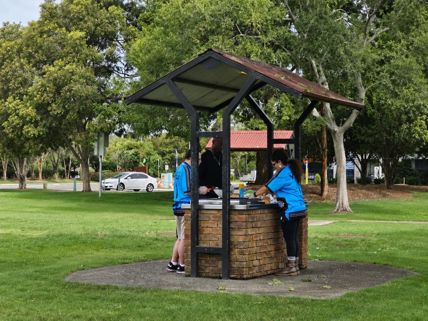 Participants and support team preparing a meal during an outdoor community activity
