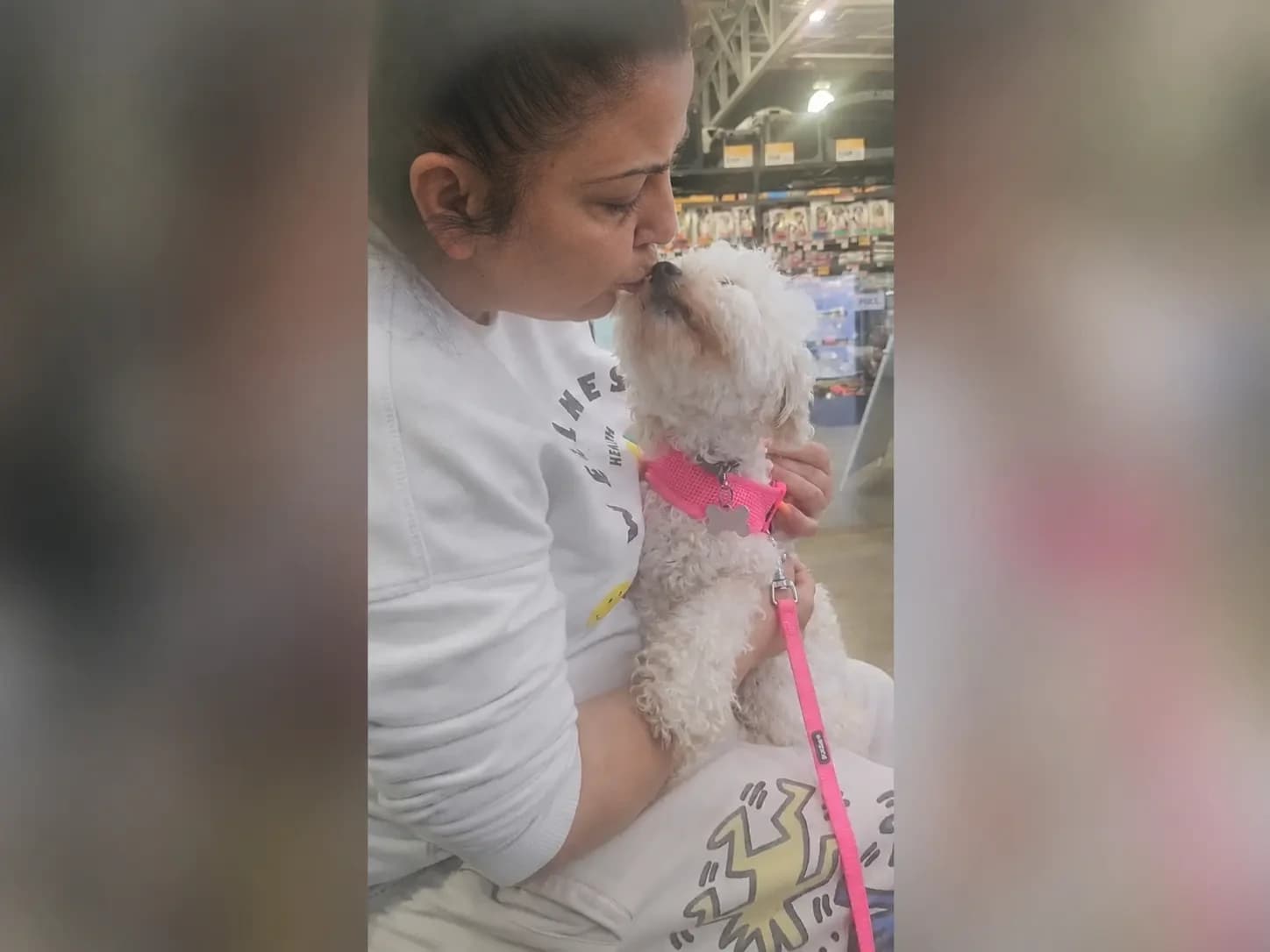 Participant enjoying a supported community outing with a small dog